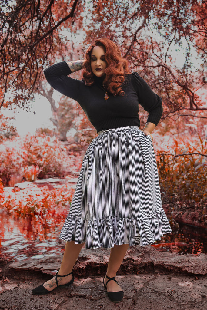 modeling wearing vintage inspired gothic skirt with black and white stripes
