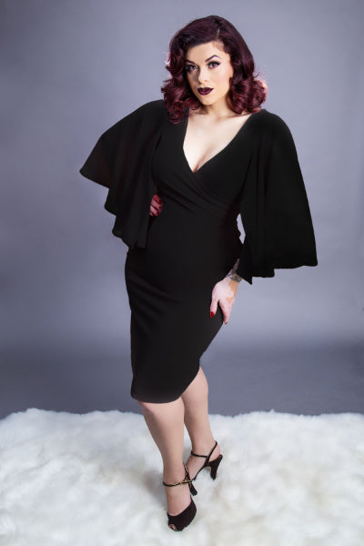 model in black wiggle dress with butter fly sleeves