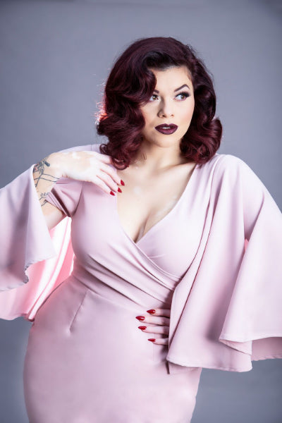 model in pink wiggle dress with butter fly sleeves